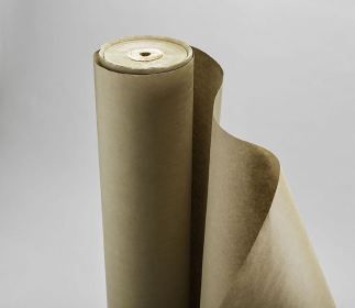 A large roll of brown paper standing upright against a plain gray background, with the edge of the paper slightly unrolled